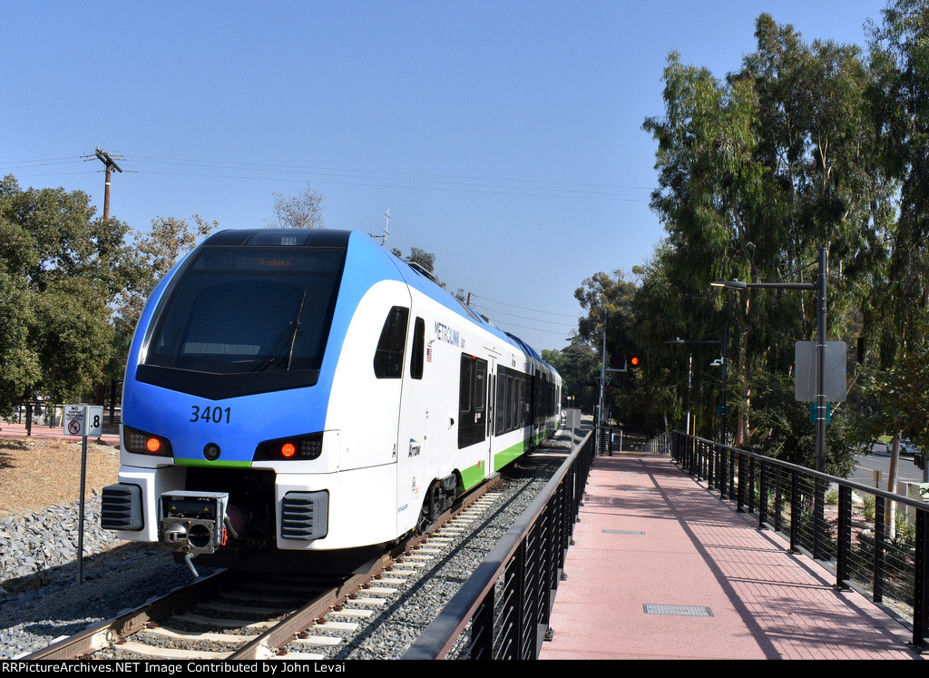 This train is heading away from Redlands ESRI Station toward the next stop of Redlands Downtown Sta